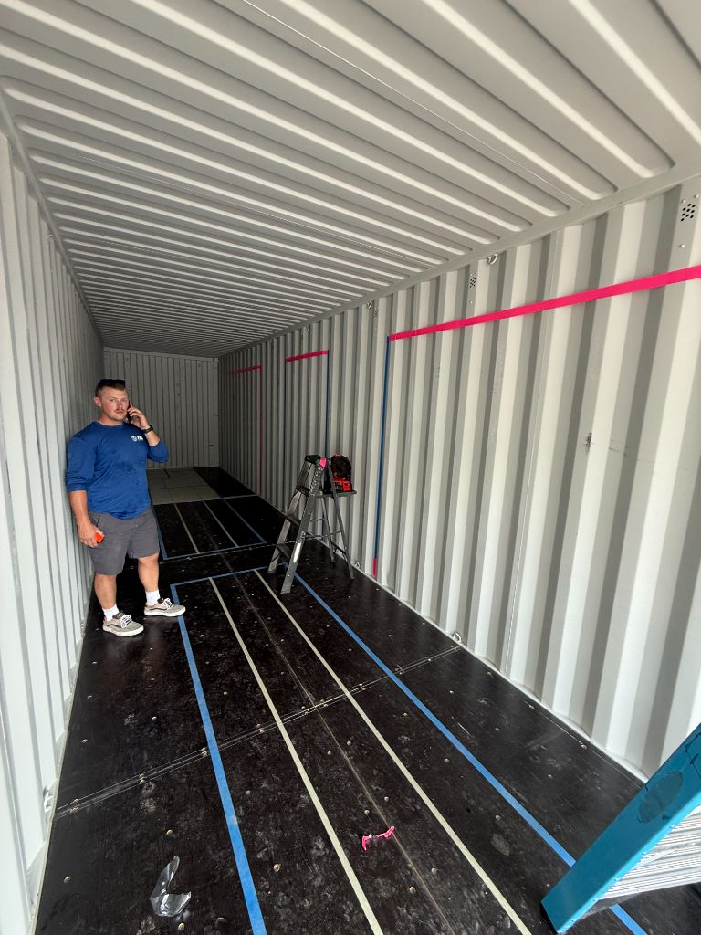 Inside the original shipping container during early construction