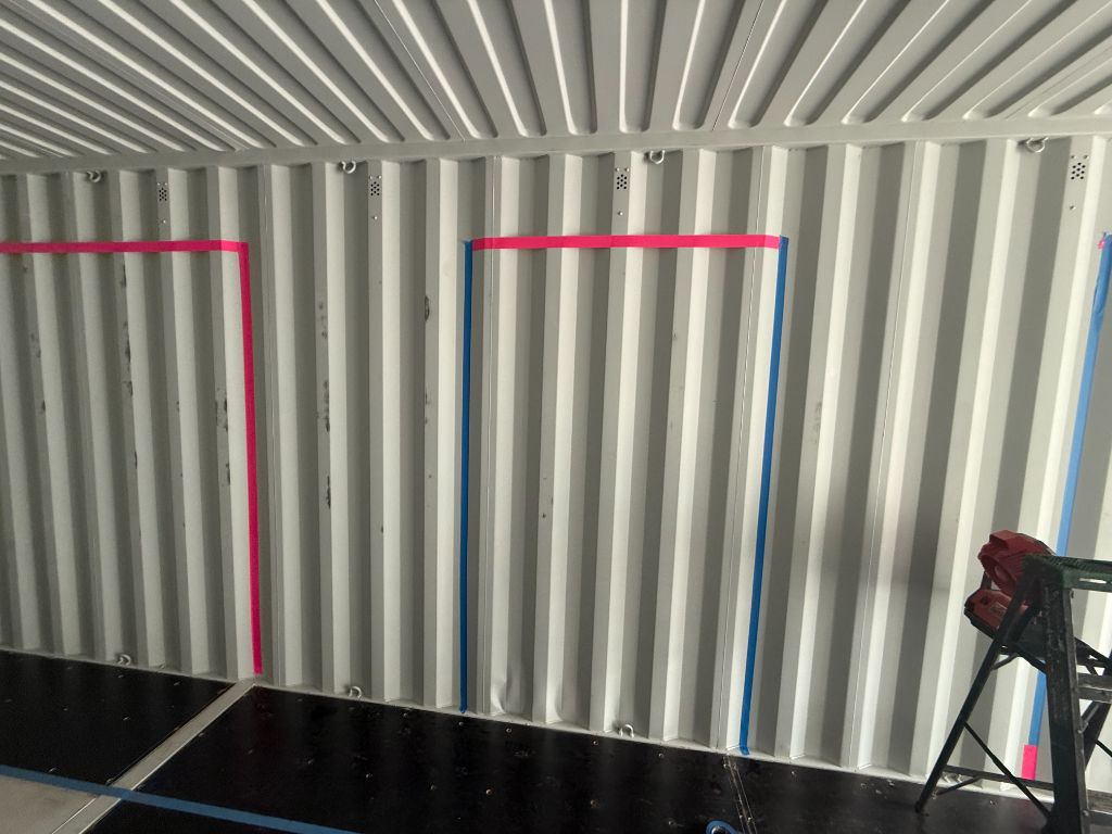 Marked wall layout inside the shipping container during construction