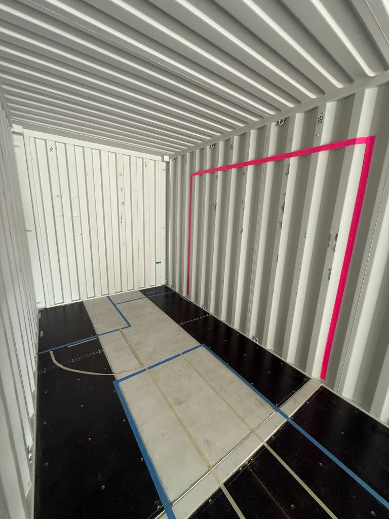 Floor planning and early construction layout inside the shipping container