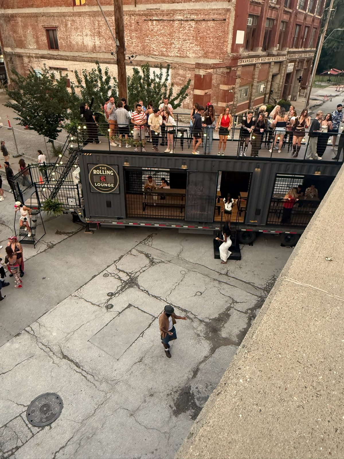 Guests filling the rooftop deck of The Rolling Lounge at an outdoor event
