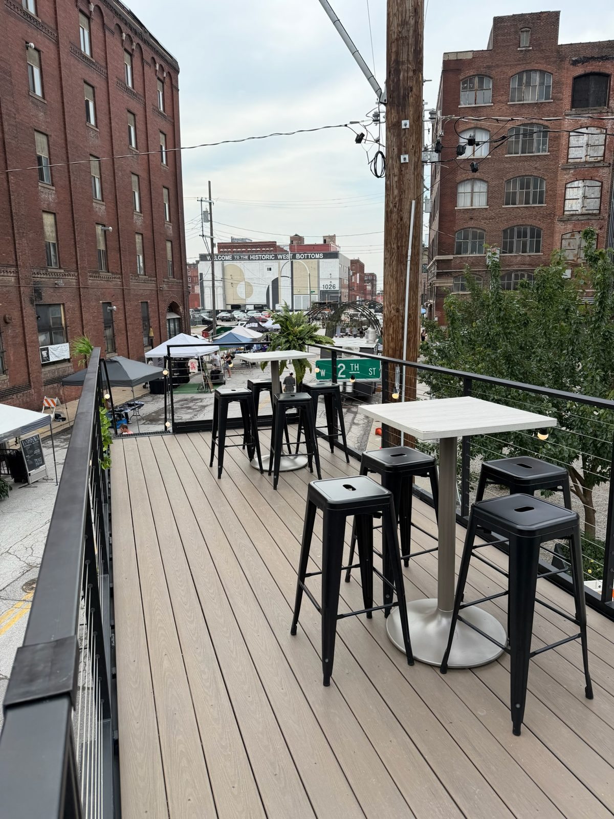 Rooftop high-tops overlooking a West Bottoms street gathering
