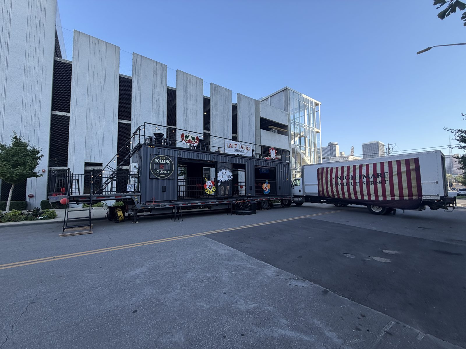 Side view of the themed lounge setup on a city street next to a parking garage