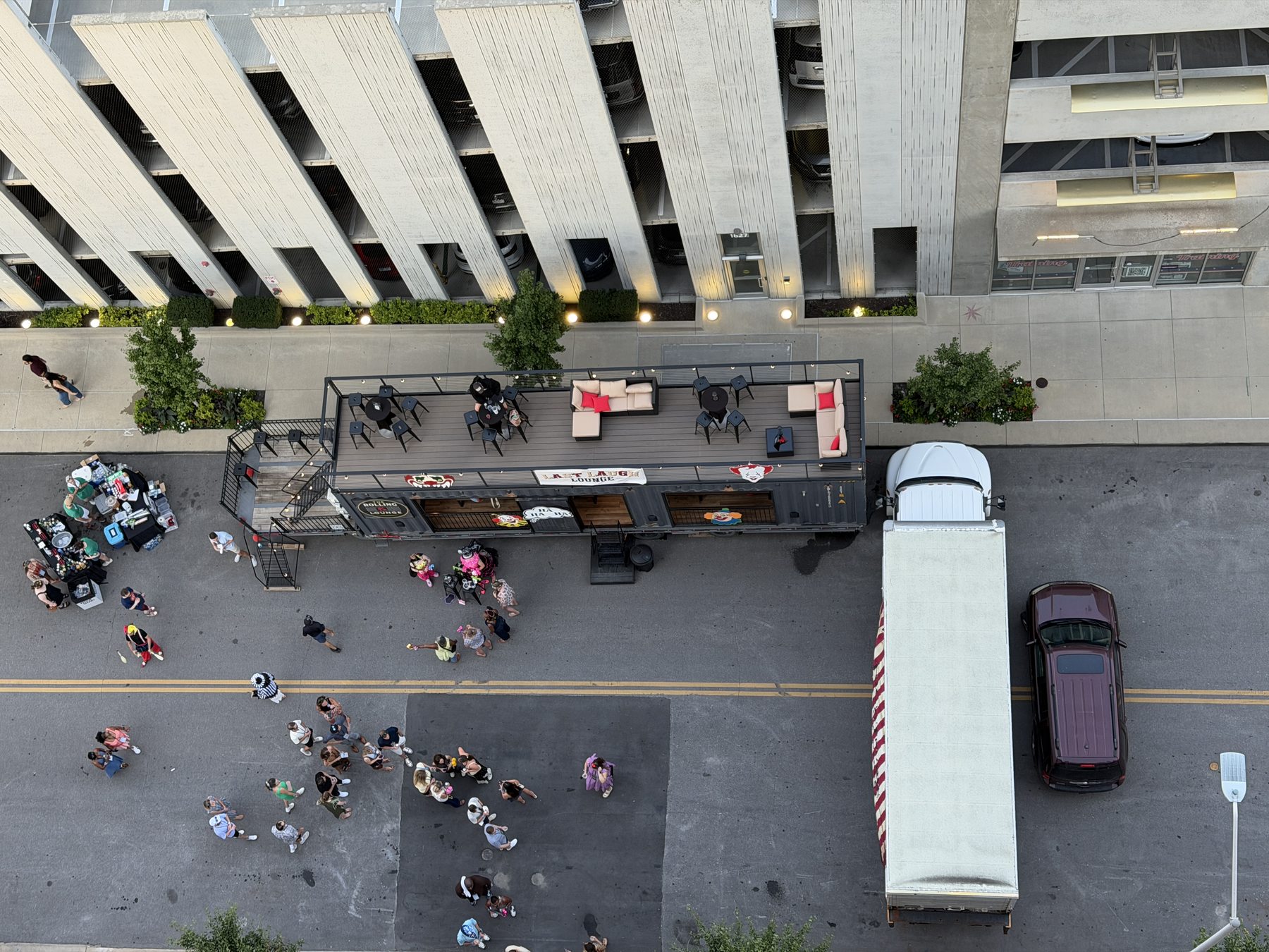 Overhead view of The Rolling Lounge on a city street with guests on the rooftop deck