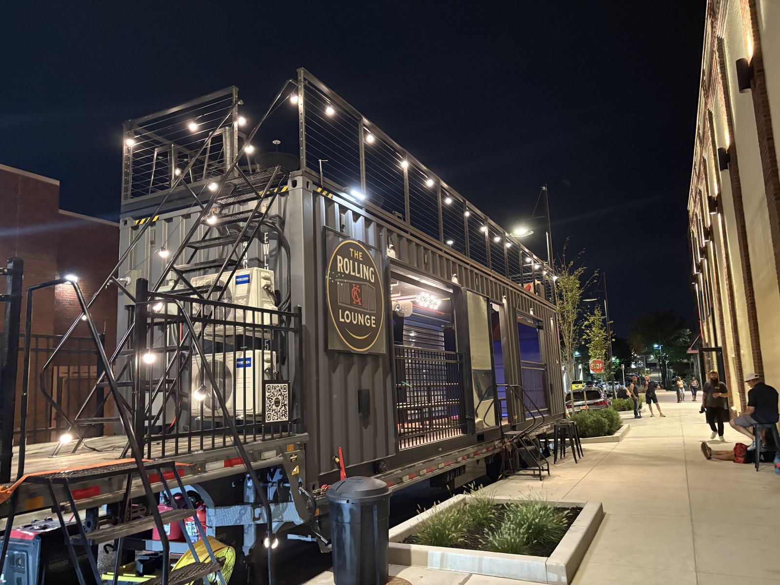The Rolling Lounge lit up on the street at night outside the Wu-Tang show