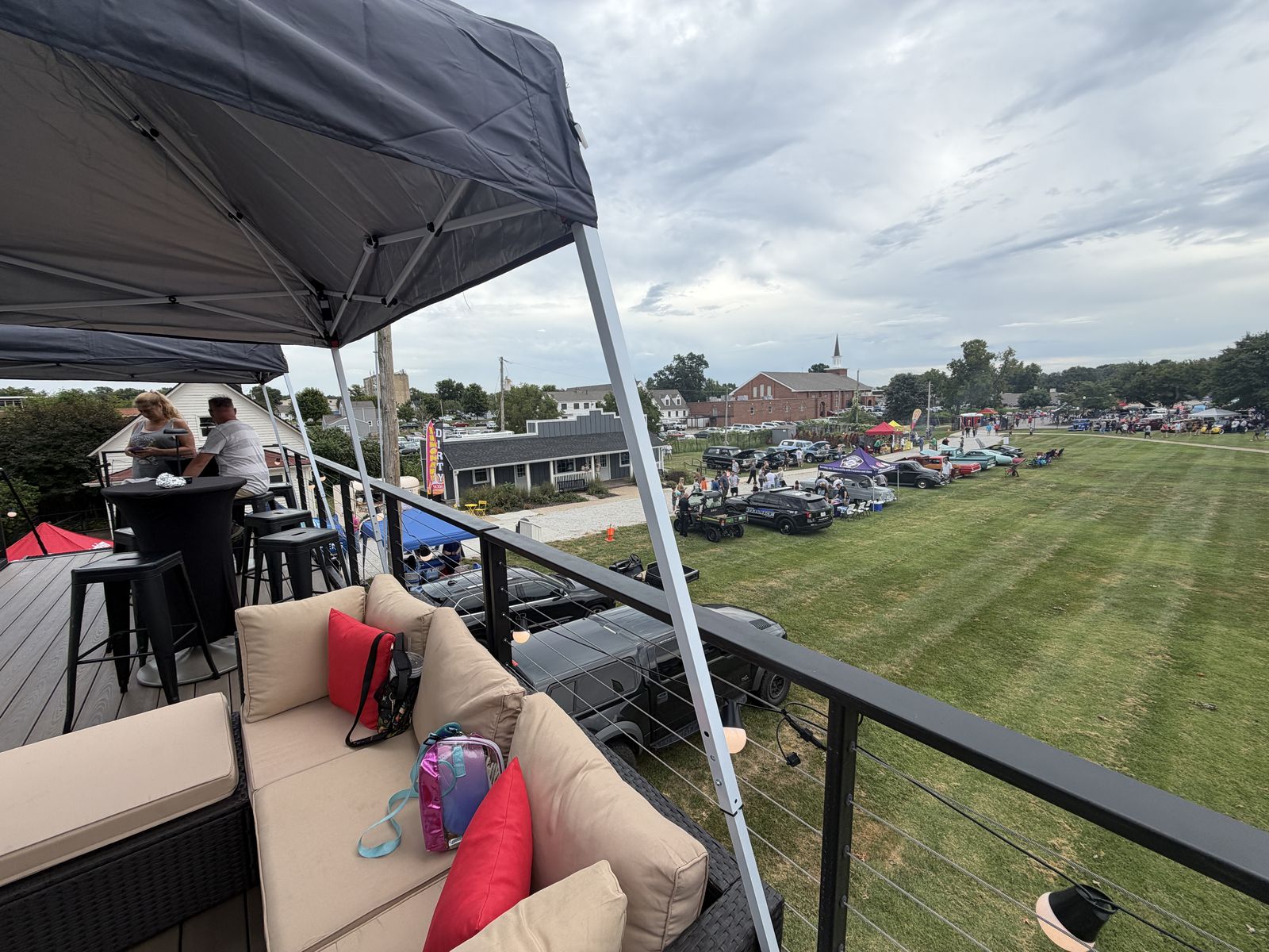 Lounge seating on the deck looking out over classic cars at Shawnee Wheels and Dreams