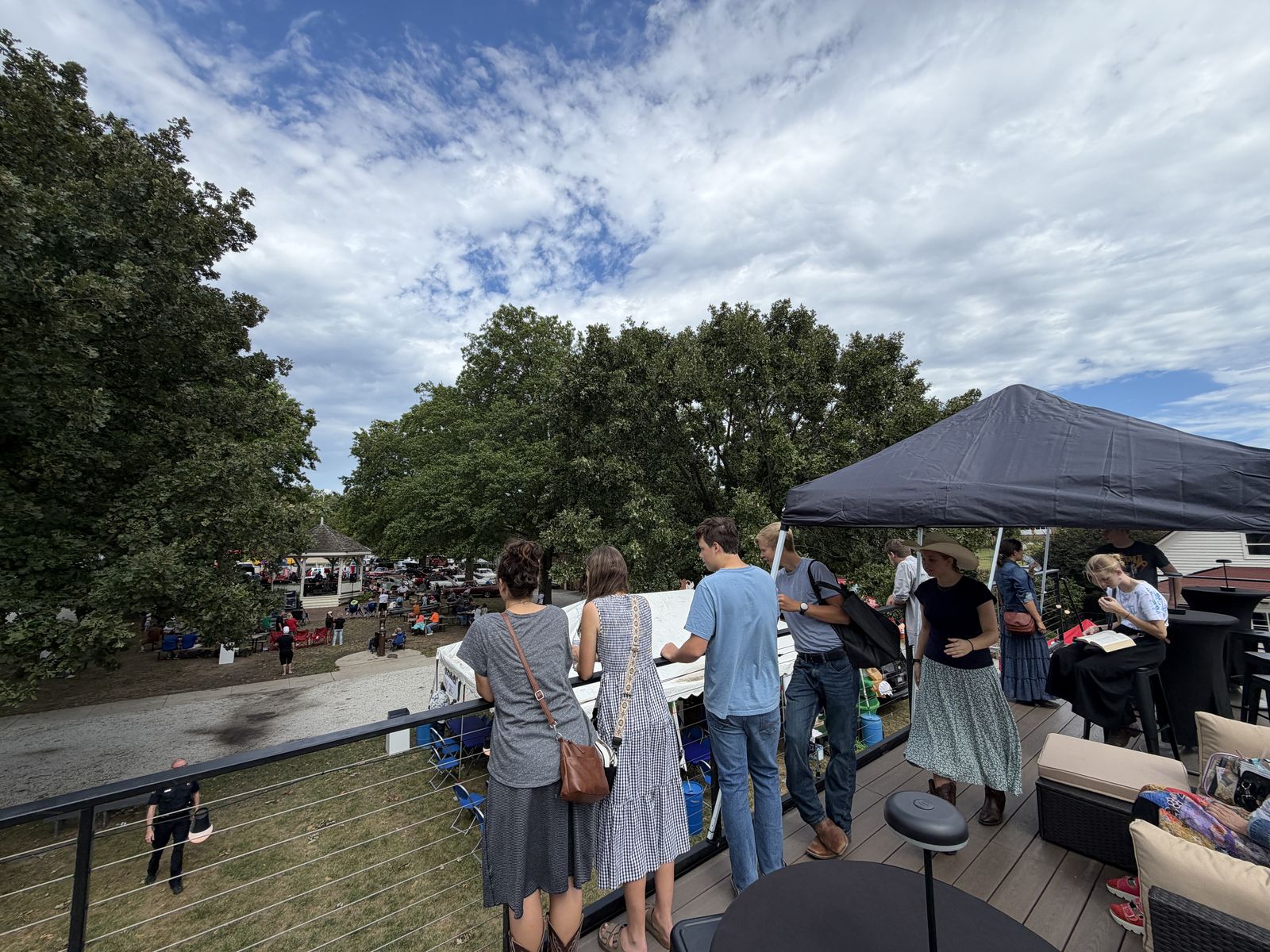 Guests at the rooftop rail watching the Shawnee Wheels and Dreams Car Show
