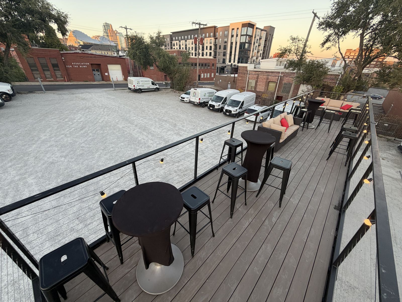 Rooftop deck at sunset during Game Show Studio, looking over the skyline with lounge seating in front