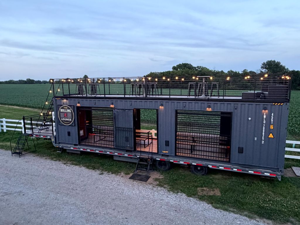 Wide nighttime view of the full two-level Rolling Lounge KC setup
