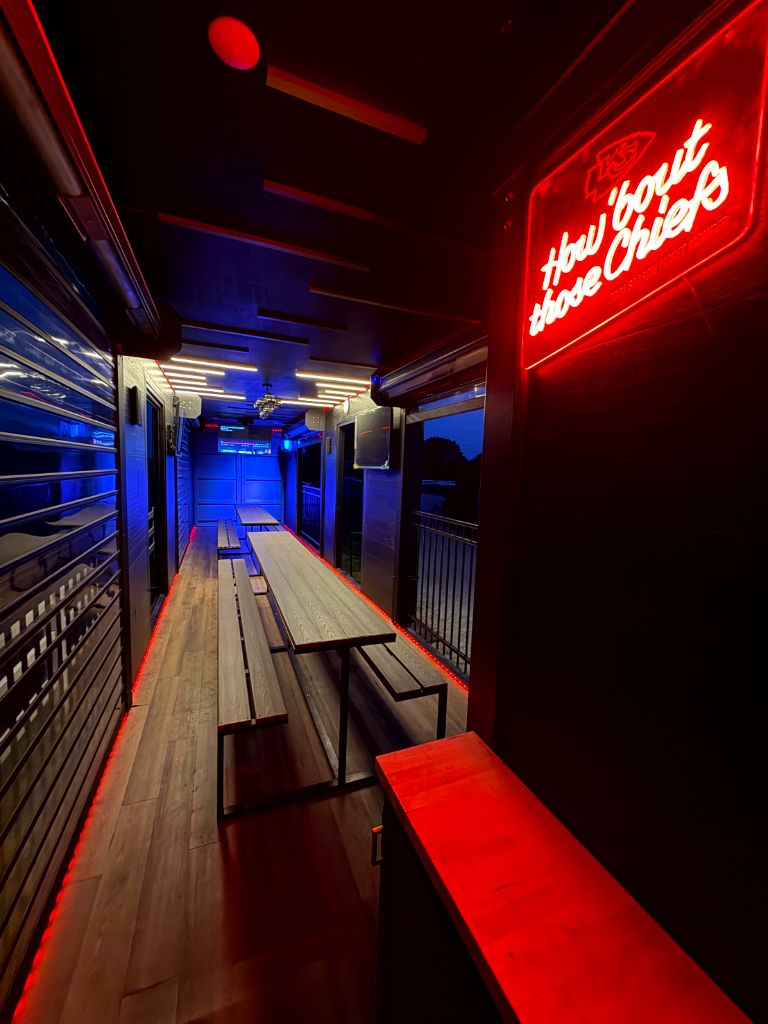 Interior with neon sign and long table seating